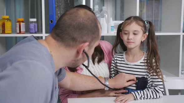 Family Male Doctor Listening with a Stethoscope Chest Little Girl