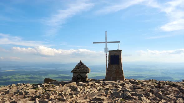 Christian Cross on a Rocky Mountain on a Sunny Summer Day