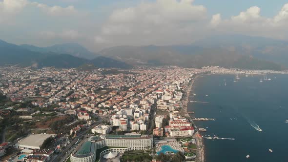 The Camera Flies Along the Coast of the City Beach in the Mediterranean Sea. Aerial View alt
