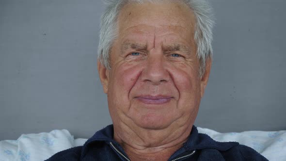 Portrait Of Old Caucasian Man With Gray Hair And Deep Wrinkles Looking At Camera alt