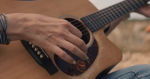 Woman Plays Guitar on Meadow alt