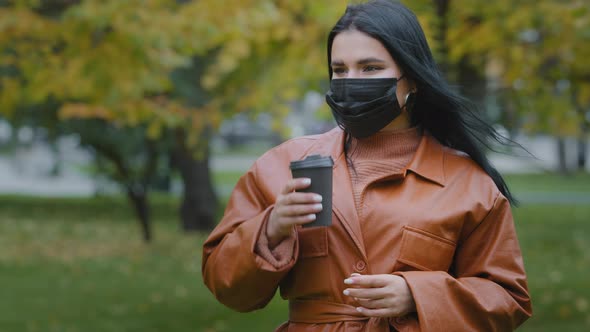 Closeup Young Woman Stands in Autumn Park Beautiful Hispanic Girl Holding Disposable Cup of Coffee alt