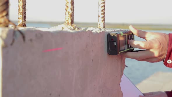 Building Engineer does Measurements of the Building alt