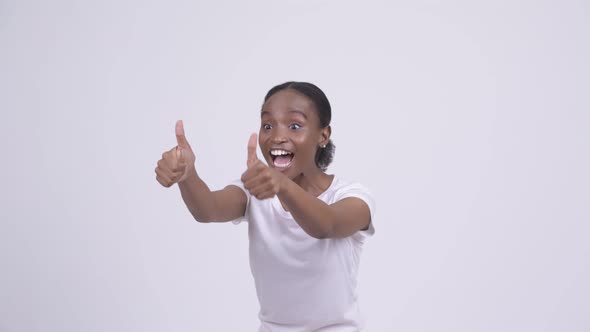 Happy Young Beautiful African Woman Giving Thumbs Up and Looking Excited alt