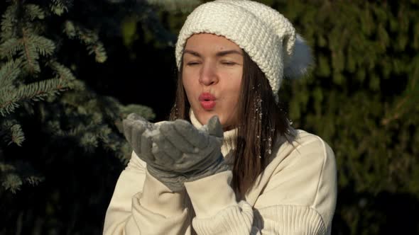 Young Cheerful Woman in Light Clothes Rejoices in the First Snow and Plays in the Forest alt