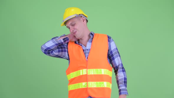 Stressed Young Man Construction Worker Having Neck Pain alt