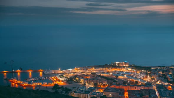 Terracina, Italy. Top View Skyline Cityscape 4K Time Lapse Transition From Dusk To Night. Blue Hour