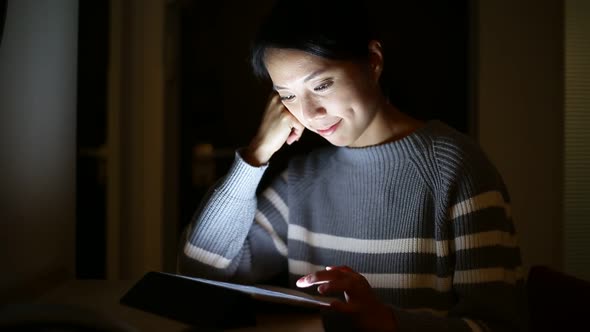 Woman use of digital tablet computer at night alt
