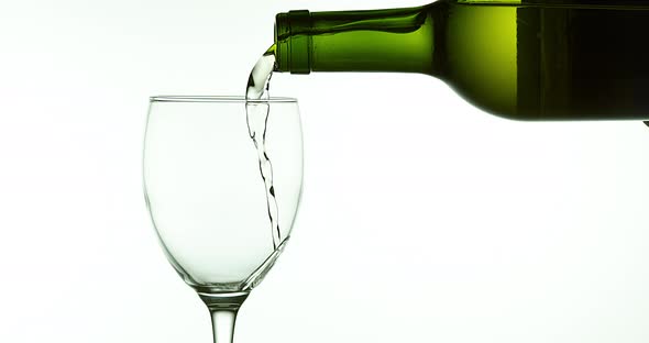 White Wine being poured into Glass, against White Background, Slow motion 4K