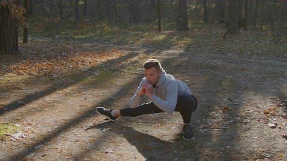 Man Is Stretching Legs Before Workout