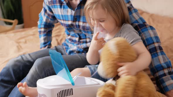 Father Helps His Daughter Use Nebulizer Sick Child Asthma Bronchitis Lung Disease alt
