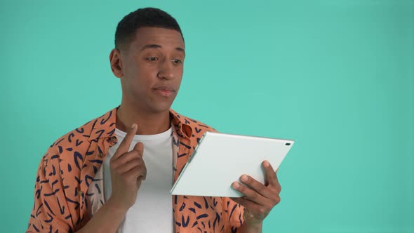 Pensive African American Man Using Tablet alt