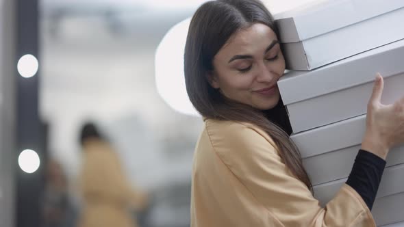 Portrait of Happy Excited Caucasian Young Beautiful Woman Holding Lot Boxes with Clothes Shoes alt