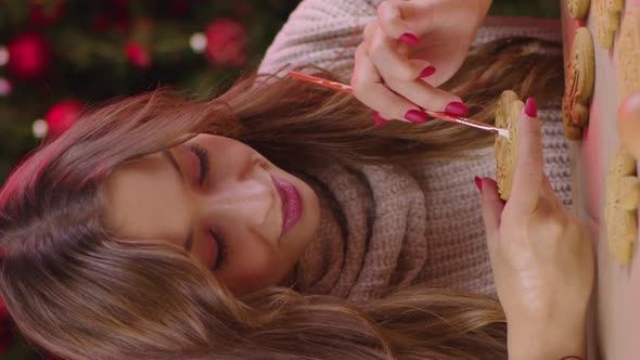 Vertical Shot Pretty Longhaired Smiling Girl Icing Heartshaped Christmas Gingerbread Cookie