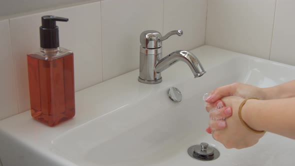Female Hands Closeup Washing in Home Bathroom Full of Daylight alt