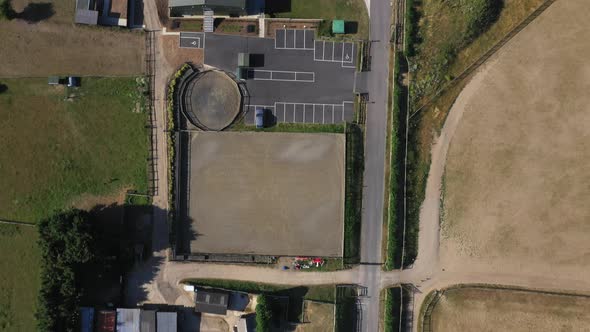 Top Down View of Working in Green Yellow Wheat Field Farn and Greenhouses