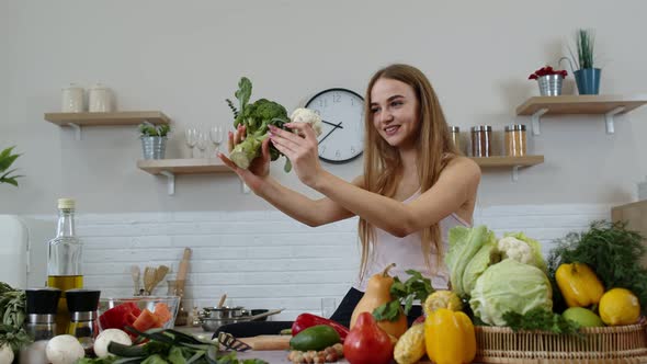 Girl Recommending Eating Raw Vegetable Food. Showing Broccoli and Cauliflower. Weight Loss, Diet alt