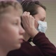 A Side View Slow Motion Portrait of a Teacher and Her Student Putting Medical Masks on Their Faces - VideoHive Item for Sale