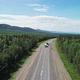 Aerial View of an Intercity Highway with Traffic Going Through a Green Forest on Bright Sunny Day - VideoHive Item for Sale