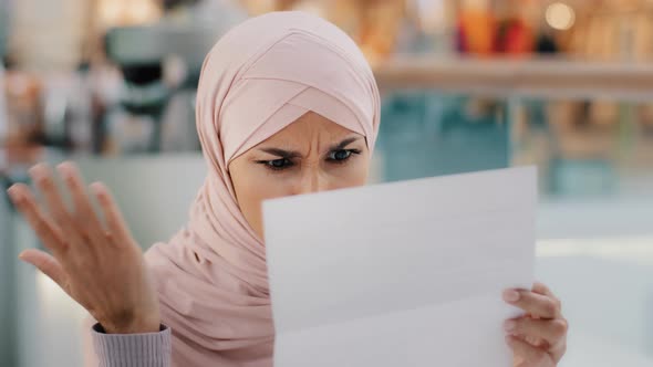 Closeup Young Muslim Woman Sitting Reading Paper Letter Bad News Frustrated Islamic Girl Shocked By alt