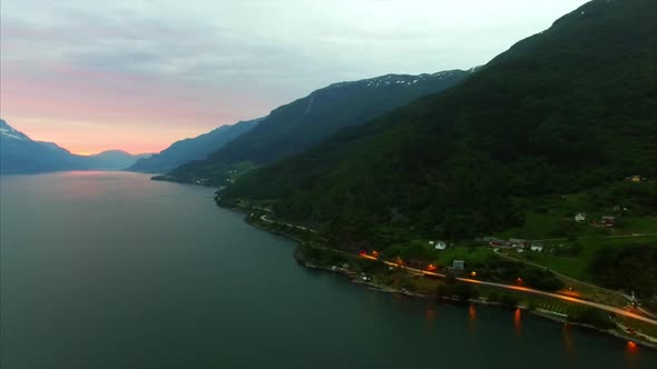 Flying over popular Hardanger fjord in Norway in the evening, aerial footage