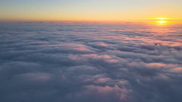 Aerial View From Above at High Altitude of Dense Puffy Cumulus Clouds Flying in Evening alt