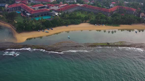 Aerial view of hotels and resorts along Bentota beach, Sri Lanka. alt