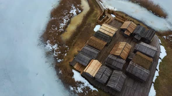 Historical Wooden Buildings on Small Island in the Frozen Lake Araisi in the Winter alt