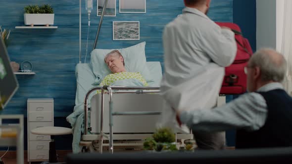 Elder Man Asking for Help From Doctor and Nurse alt