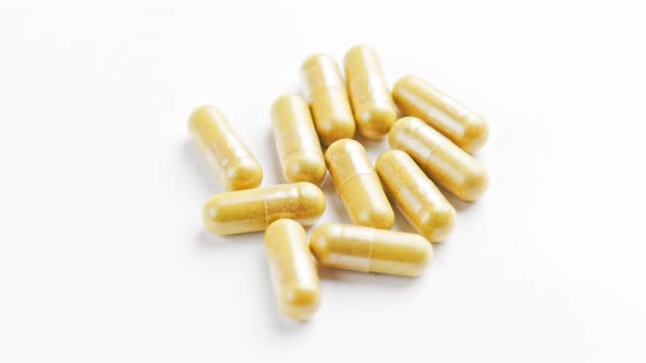 Transparent Capsules with Brown Dried Organic Powder Inside Closeup Spinning Loop