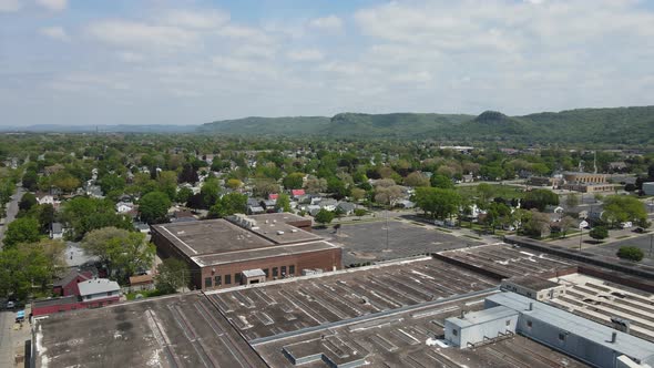 Large industrial building with residential neighborhood surrounding the business. Blue sky in summer