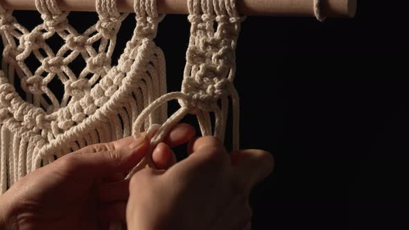 Woman Weaves Pattern of Macrame Threads with Her Own Hands for Decoration or Home Decor alt