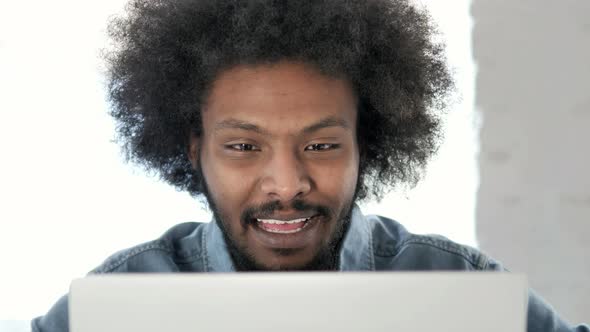 Close Up of Online Video Chat on Laptop at Work By African Man alt