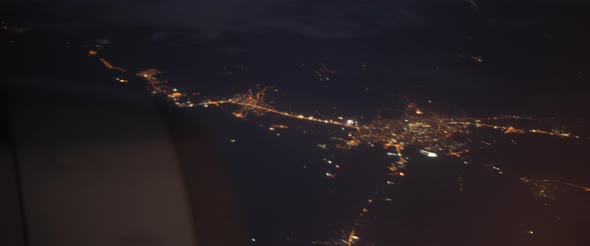 Aerial view of Istanbul from plane window at night. Plane flying above Turkey alt