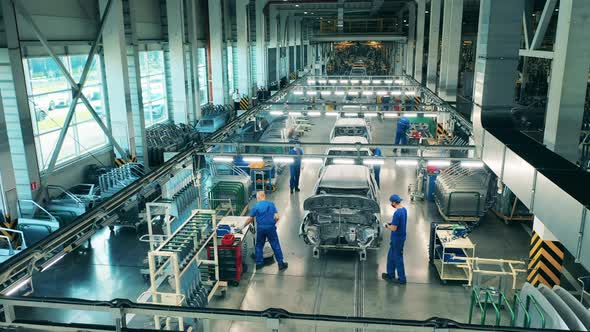 Timelapse of Factory Workers Assembling Cars. Automobile, Car Factory Conveyor. alt