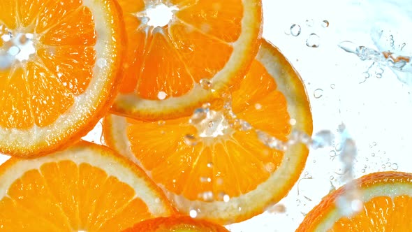 Super Slow Motion Shot of Splashing Orange Slices at 1000Fps alt