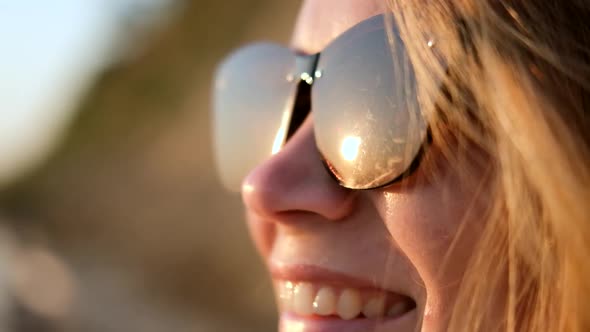 Closeup Portrait of Attractive Smiling Girl in Glasses Reflection of Sunset alt