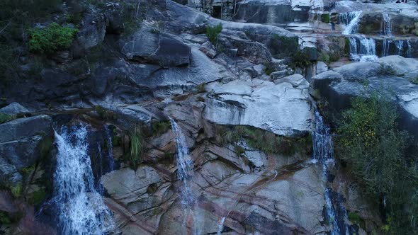 Waterfall Surrounded By Rocks alt