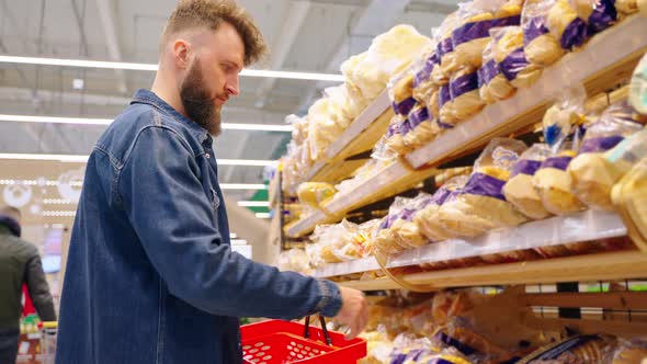 Man Buying Bread in the Supermarket After Checking Sellby Date alt
