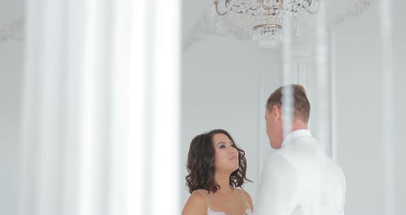 Bride and Groom Kissing Wedding Couple Indoors Looking at Each Other Beautiful Girl Model in White alt