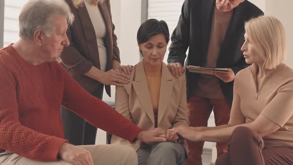Mature Woman Crying at Support Group Meeting alt