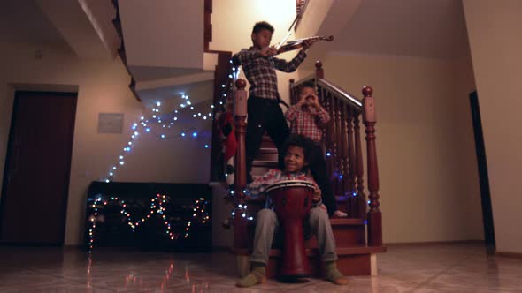 Three Kids Playing Christmas Music. alt