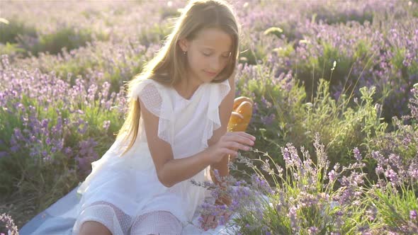 Cute Girl in Lavender Flowers Field