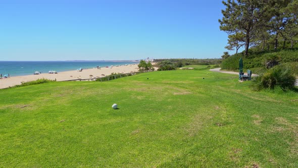 Grassy Field Near a Pleasant Looking Beach and Glistering Ocean Water in Vale Do Lobo Portugal alt