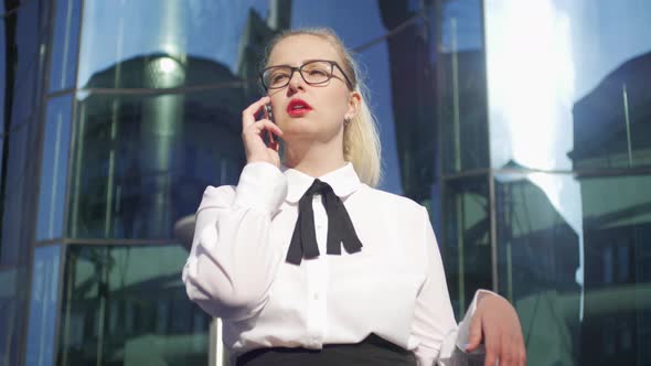 business woman talking on the phone on the background of the business center