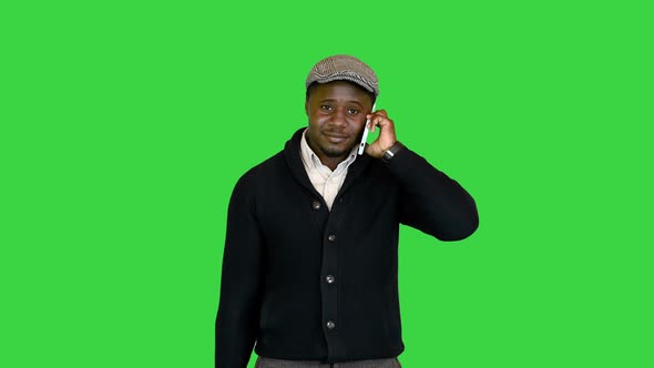 Handsome Black Guy with a Bag Talking on the Phone on a Green Screen Chroma Key alt