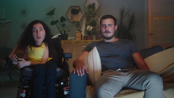 Surprised Couple Watching Movie at Home alt