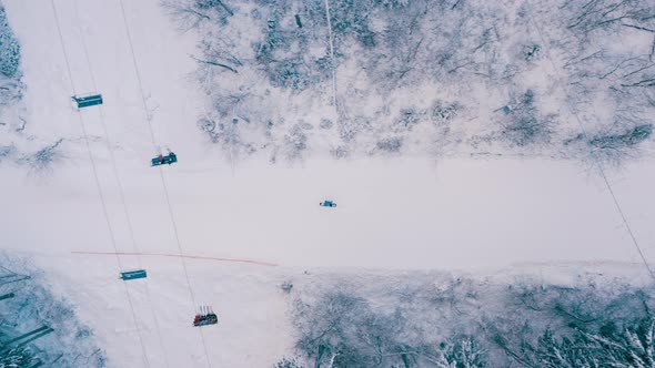 Aerial View of Snowy Snowboarder Ride Alone on a Narrow Mountain Track