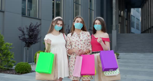 Group of Young Women in Casual Dresses and Top Wearing Masks to Protect Coronavirus Pandemic alt