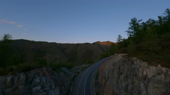 Aerial View Empty Serpentine Asphalt Road Highway on Mountain Summit Darkness Cliff Stone Texture alt
